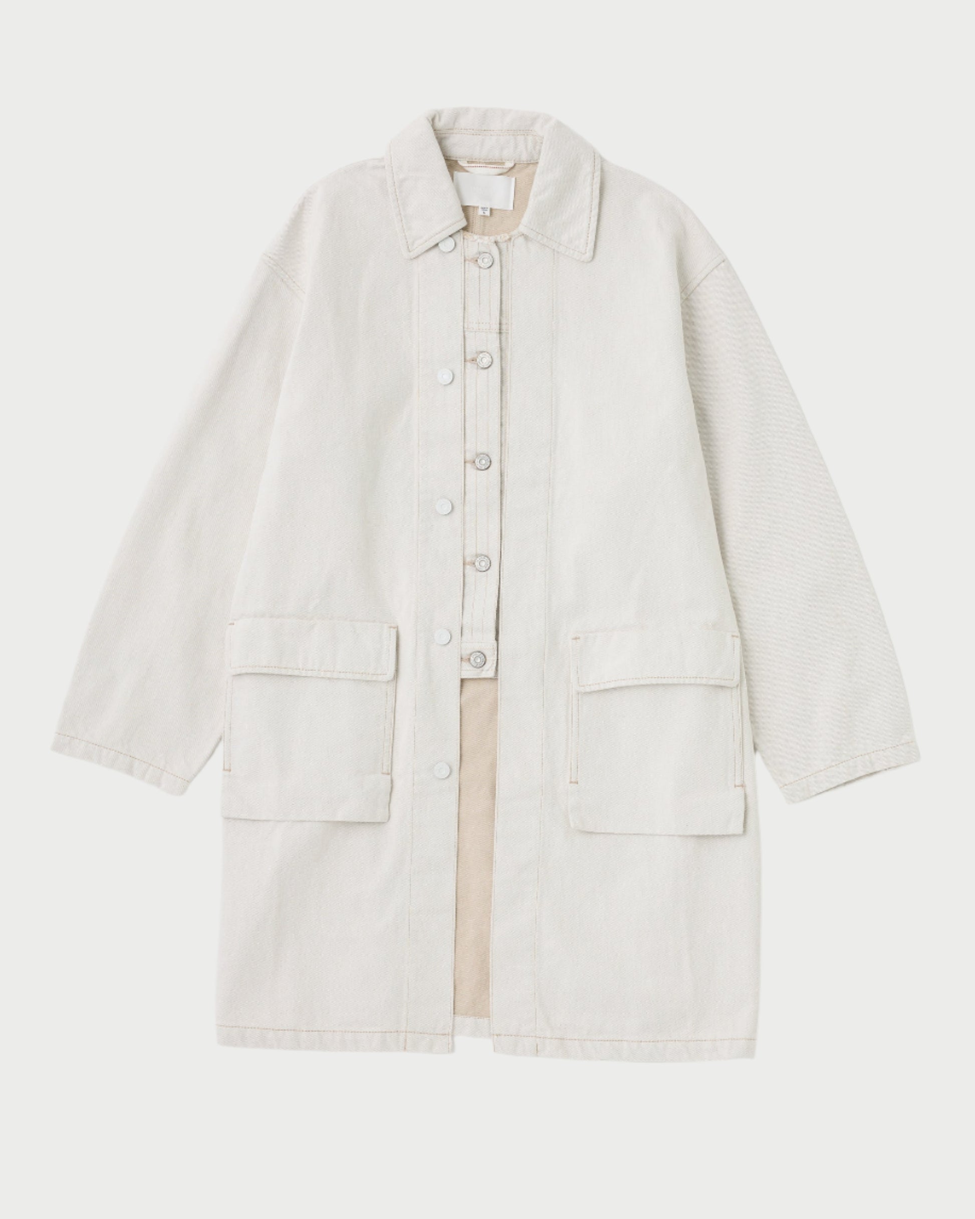 Set against a plain backdrop, the Hanson Layered Jacket by Moussy is an ideal beige button-up coat for Spring transitions. It boasts a collar, long sleeves, and two large front pockets, merging style with practicality for any changing season.