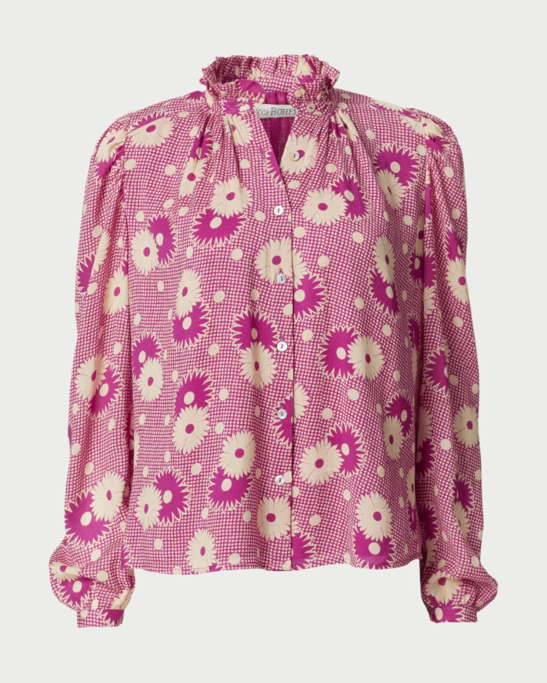 Introducing the Annabel Berry Daisy Shirt by Alix of Bohemia: a vintage-inspired blouse in pink and white with an elegant ruffled collar and long sleeves. The design features large, daisy-like flowers on lightweight fabric. This retro floral shirt includes a button-up front and gathered shoulder details for added charm.