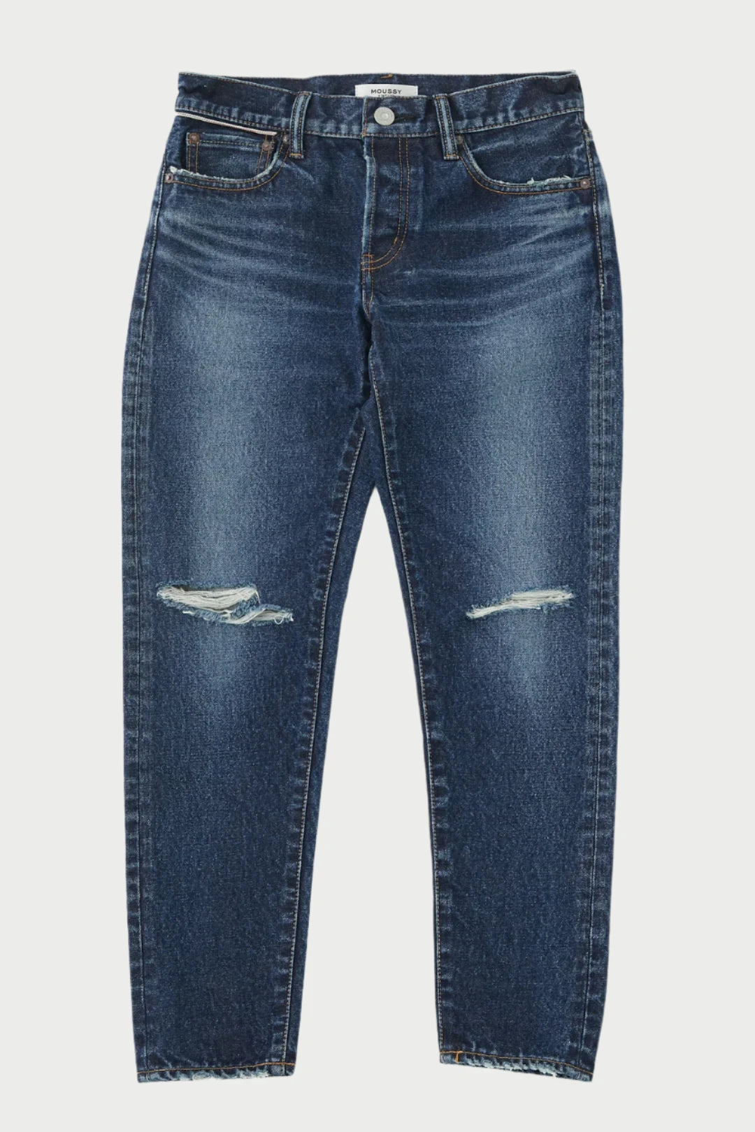 Image of a pair of dark blue, Rosemead Tapered Jeans by Moussy featuring a mid-rise waist and a straight leg cut. The jeans have a slightly worn look with light distress marks on both knees and frayed hems at the ankles. They include standard front and back pockets with button and zipper closure.