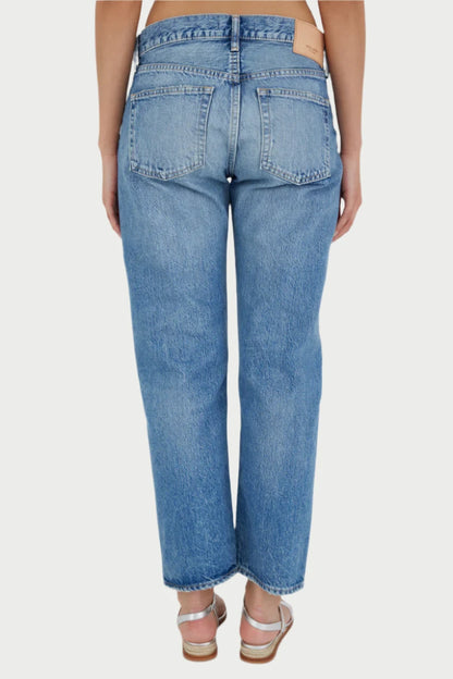 A person is shown from the back, wearing high-waisted, light blue MAPLECREST BOYS JEANS by Moussy with a straight-leg cut. The jeans have two back pockets and a leather patch near the waistband. The individual is also wearing silver strappy sandals. The background is plain white.