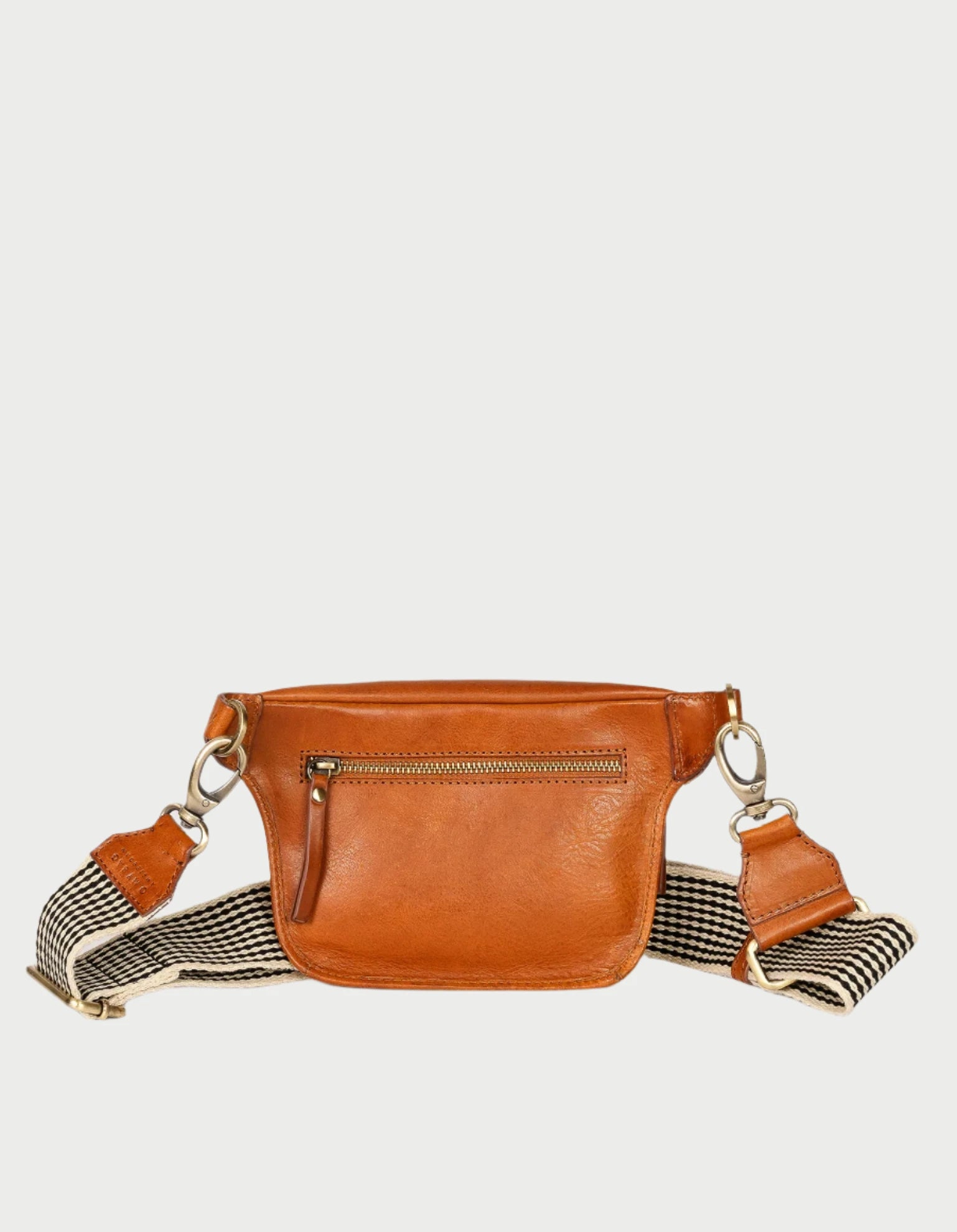 The Beck's Bum Bag in Cognac by O MY BAG showcases a minimalist design, featuring a brown leather construction with a front zipper pocket and chic black-and-white checkered strap. Adorned with silver hardware, this versatile accessory is perfect for those who appreciate stylish functionality. Displayed against a plain white background, it effortlessly complements any outfit.