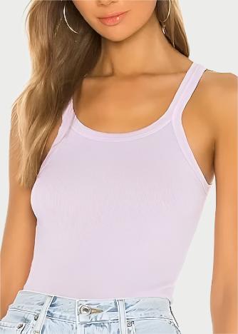 A woman is dressed in the Ribbed Tank Lilac from RE/DONE and light denim jeans. Her hair cascades down, complemented by hoop earrings. The spotlight is on her outfit, with the tank made from 100% cotton offering superior comfort and style.