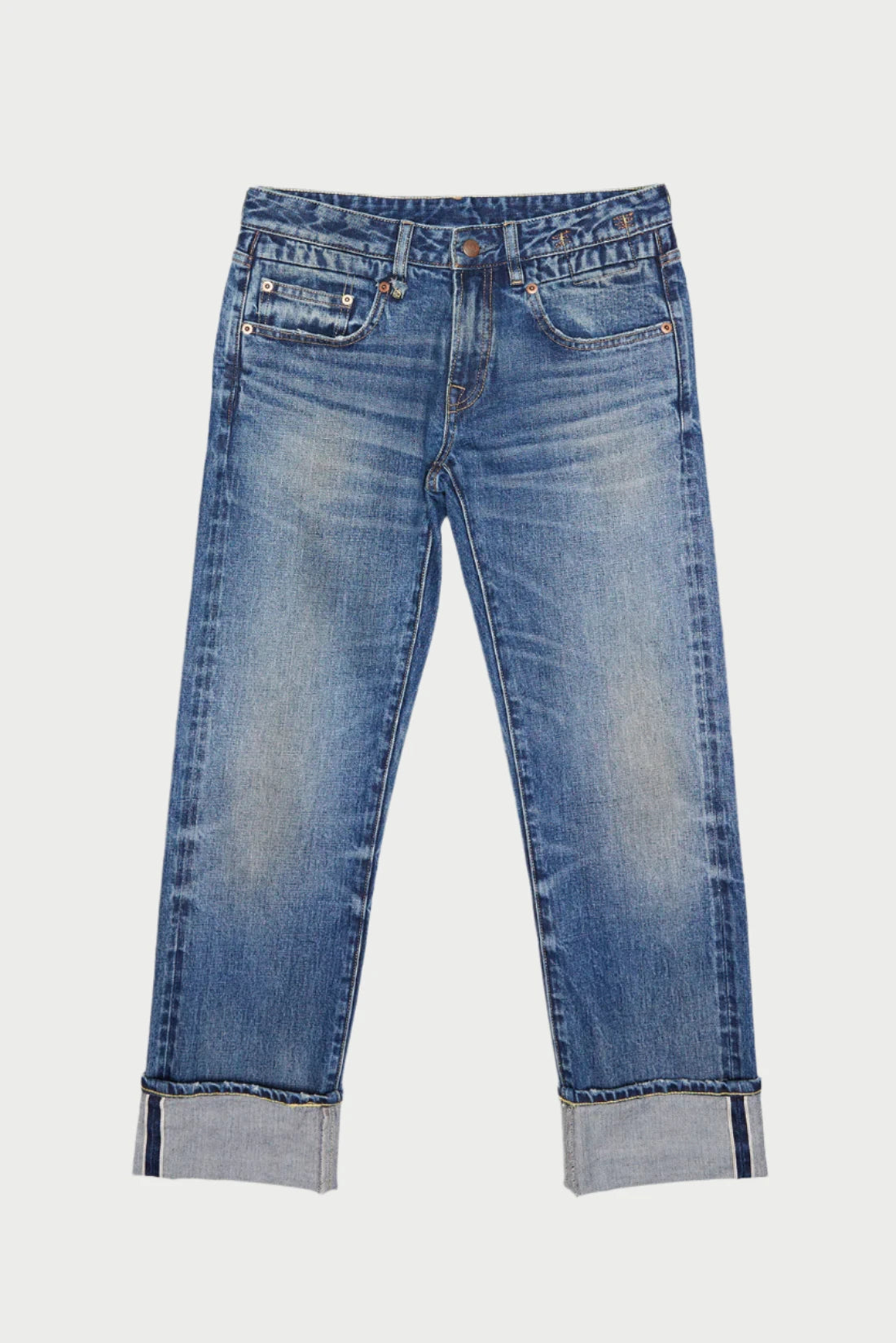 A pair of R13 Cuffed Boy Straight denim jeans with a slightly faded finish, featuring front pockets and rolled-up cuffs. The slim fit Boy Straight design is laid flat on a light background, boasting a classic button and zipper closure.