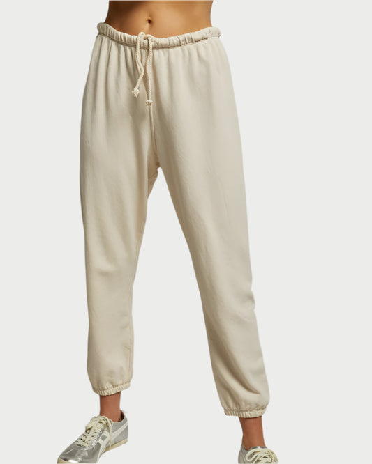 A person models the perfectwhitetee French Terry Jogger Sugar, featuring an elastic waistband and drawstring, against a plain background. The joggers are styled with silver sneakers, focusing on the lower body for a comfortable look.