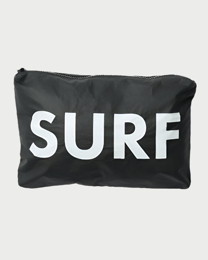 The LOCAL BEACH Printed Pouch-Beach is a sleek black bag made from water-resistant Tyvek fabric with "SURF" printed prominently in large white letters on the front.