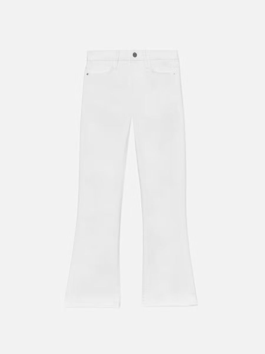 Le Crop Mini Boot Jeans in White by Frame, styled with classic five-pocket detail and a button closure, are set against a plain white background. These jeans feature a contour waistband that creates a flattering silhouette.