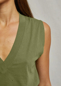 Close-up of a person wearing an olive green perfectwhitetee Margot-Safari sleeveless t-shirt with a deep V-neckline, perfect for safari or everyday wear. Only part of the person's body is visible from the neck to the torso, and they have long brown hair. The background is plain and light-colored.