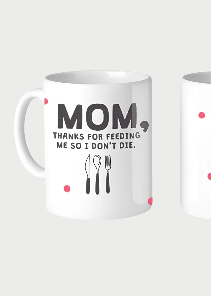 Two white ceramic mugs are shown. The front of the 11oz left mug, the Thanks For Feeding Me Mug by 365 Printing Inc, features text that reads, "MOM, THANKS FOR FEEDING ME SO I DON'T DIE," along with illustrations of a spoon, knife, and fork. The right mug, made in the USA by 365 Printing Inc., is decorated with scattered small pink dots.