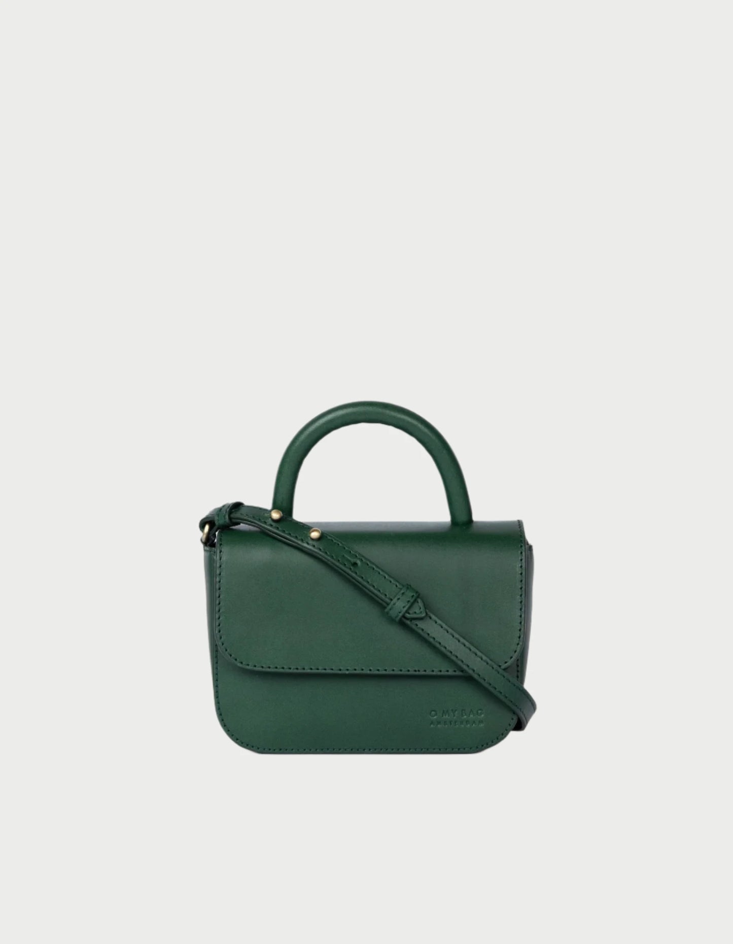 A small dark green leather Nano Bag by O MY BAG, featuring a short handle, a detachable crossbody strap, and a flap closure with a minimalistic design, set against a plain white background.