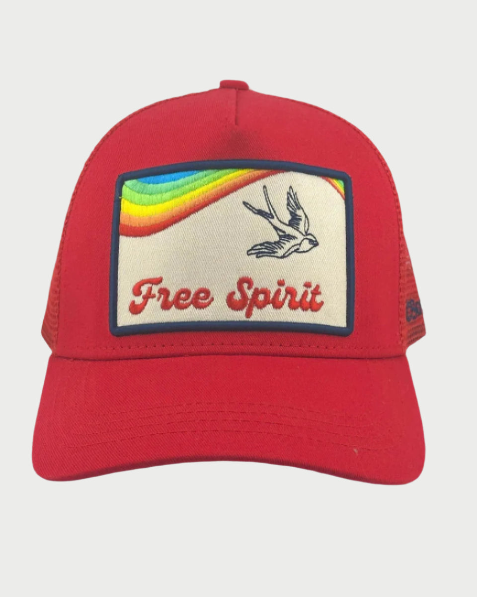 The Soulbyrd Free Spirit Trucker Hat is a red cap featuring a patch with a flying bird and rainbow, capturing the essence of adventure. Designed to fit most, it perfectly embodies the spirit of freedom.