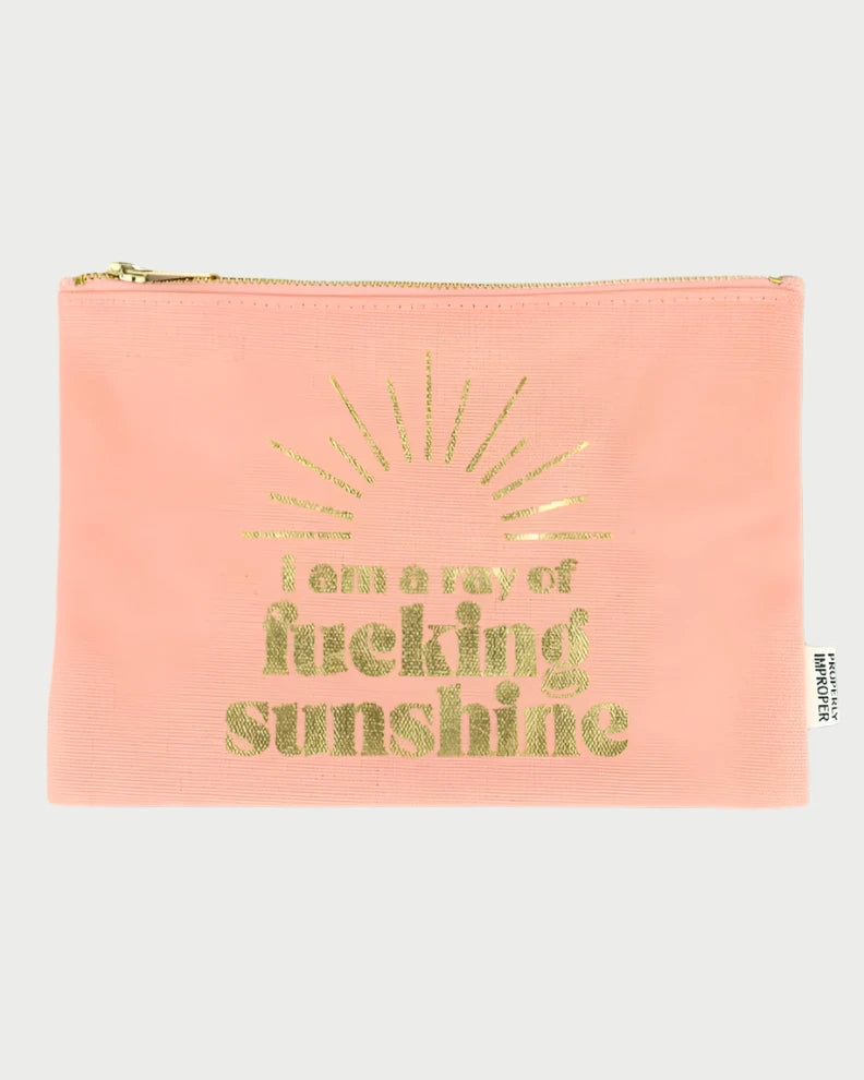 The Properly Improper "Improper Pouches" features a robust pink zippered pouch adorned with gold text and a sunburst design that proudly declares, "I am a ray of fucking sunshine." This cheeky gift is ideal for those who confidently embrace their inner radiance.