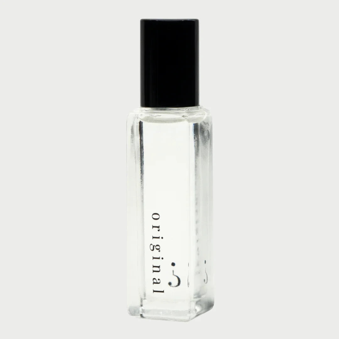 The Riddle Roll-On Oil in Original 20ml by Riddle Oil features a clear glass bottle with a black cap, labeled "original" in lowercase letters on the side. Celebrated for its natural scent and understated charm, this sleek and sophisticated bottle has developed a devoted fan base. It sits against a plain, light background.