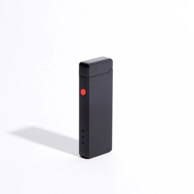 A sleek, rectangular black Pocket USB Lighter by USB Lighter Co features a red button on its side. This windproof device showcases a compact design that casts a subtle shadow on a white background.