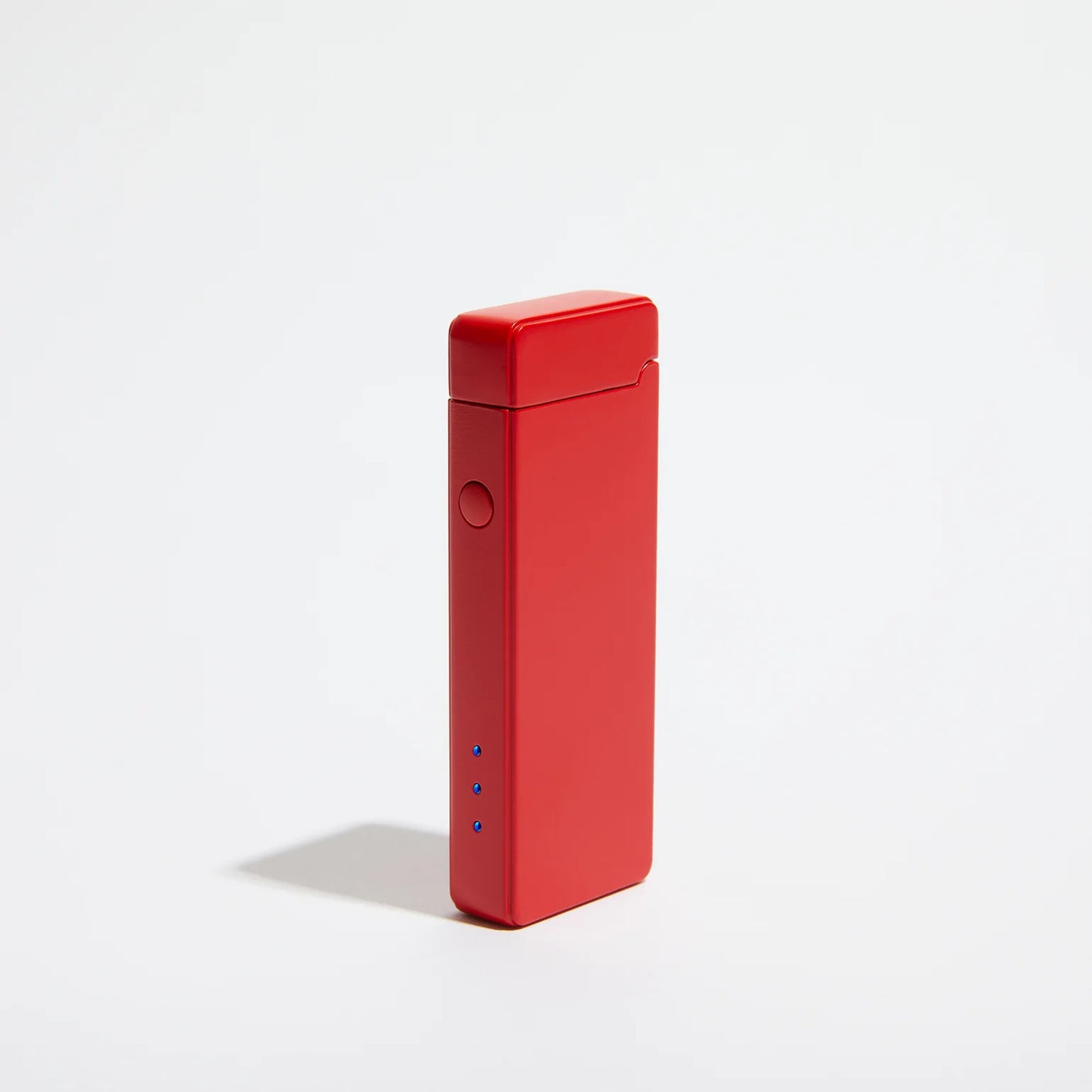 A rectangular Pocket USB Lighter in red by USB Lighter Co is displayed against a plain white background. It includes a side button and three blue LED indicator lights near the bottom, providing convenient recharging capabilities. This sleek design offers easy portability and modern style for any tech-savvy user.