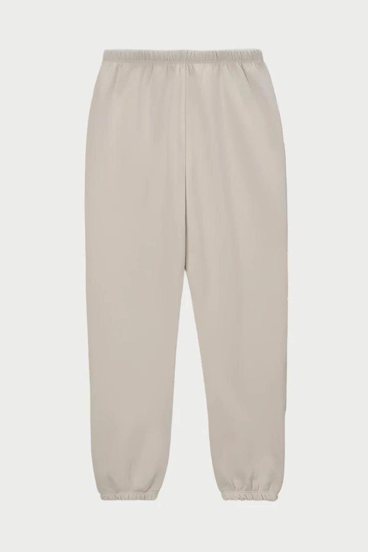 A pair of beige, relaxed fit jogger sweatpants with an elastic waistband and elastic cuffs at the ankles. The Stevie Sweatpant Pashmina from perfectwhitetee features a discreet drawcord, emphasizing a comfortable and casual style without any visible logos, patterns, or pockets for elevated loungewear.