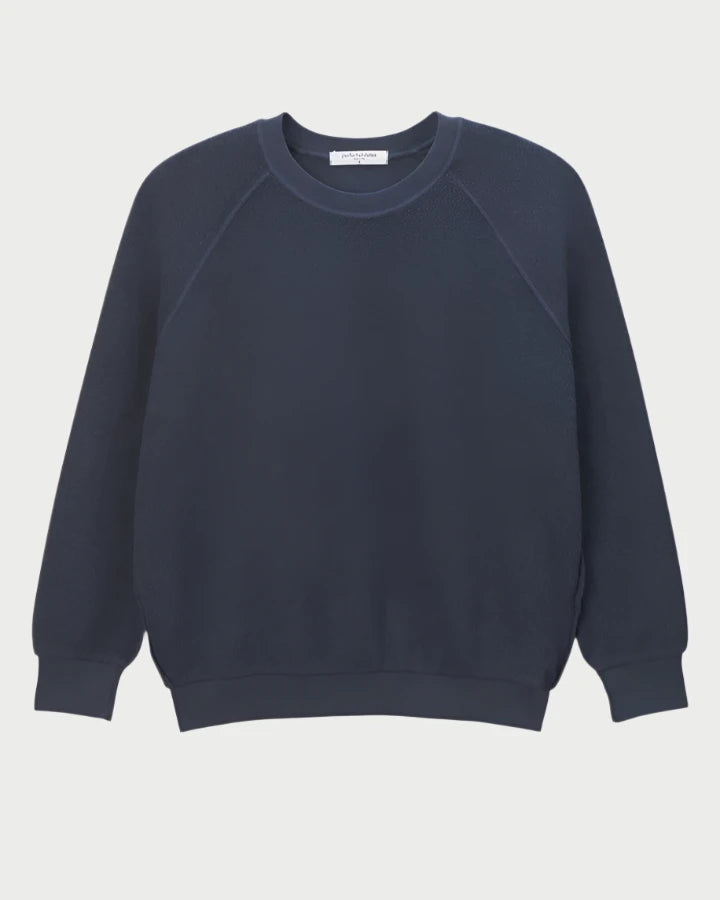 The Ziggy Sweatshirt by perfectwhitetee is a classic black crewneck with long sleeves, crafted from buttery soft fleece, showcased against a light background.