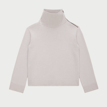 The Bowery Knit Sweater by WE-AR4 showcases a stylish white design with a front zipper, expertly crafted from high-end deadstock materials for an environmentally conscious touch.