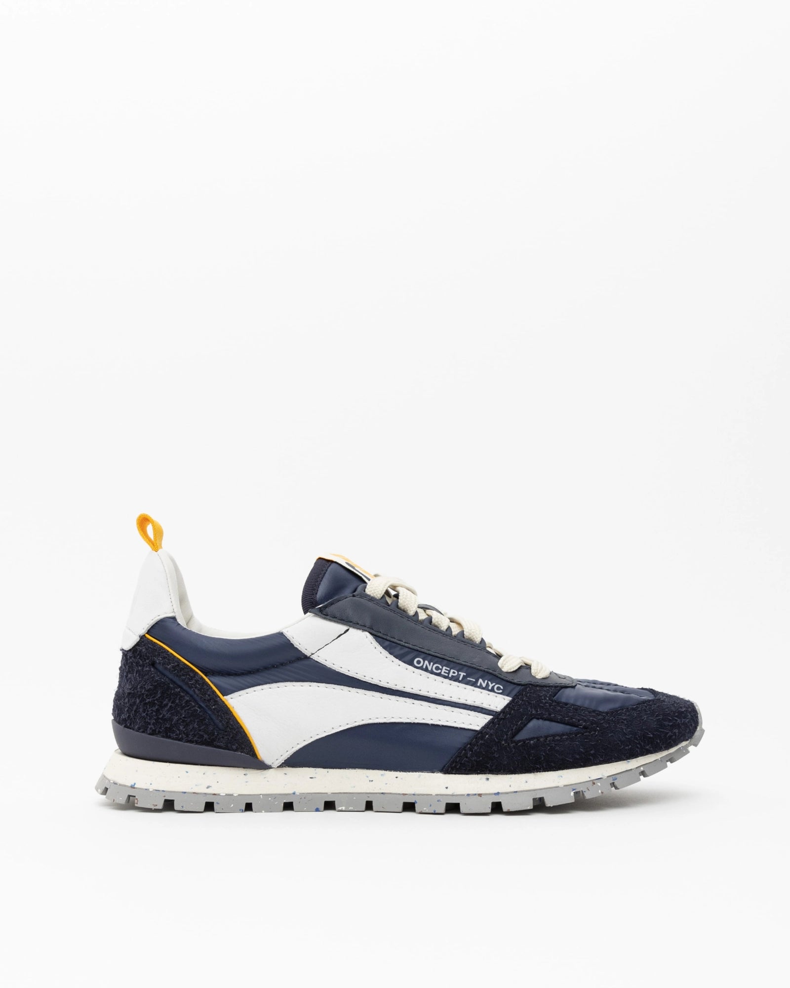 The Toronto Shoe by Oncept is a stylish single sneaker in navy, white, and gray with yellow accents. It features a textured sole and a logo on the side. This modern, sporty design combines lightweight materials with a pull tab on the heel, making it an ideal choice for sneaker enthusiasts.