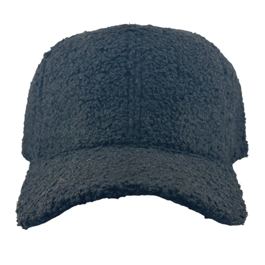 A black Teddy Trucker Hat by Soulbyrd is showcased on a simple white backdrop. Its fuzzy texture offers a cozy feel, featuring a curved brim and a snug fit design, ideal for adding warmth to your style.