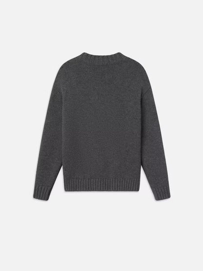 A dark gray, long-sleeved oversized Chunky V-neck Sweater by Frame, crafted from a luxurious cashmere-wool blend. The sweater features ribbed cuffs, hem, and neckline and is shown laid flat against a plain white background with the back facing the camera—an ideal choice for the Fall season.