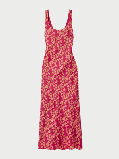 The Adele Dress by Alix of Bohemia is a sleeveless silk slip dress in pink, showcasing yellow flowers on a bias cut. It features a scoop neckline, fitted waist, and a slightly flared hem.