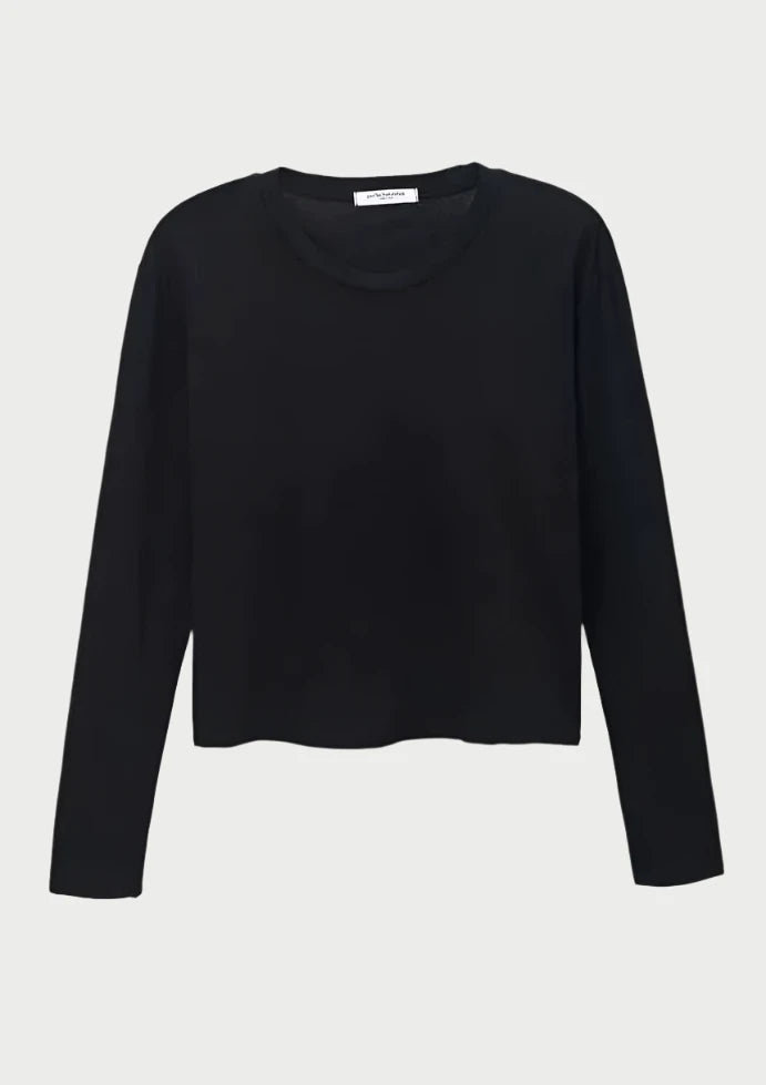 A black, long-sleeve crew neck t-shirt on a white background. The shirt is made of 100% cotton and has a slightly loose fit with a simple and minimalist design. It is the "Long Sleeve Tee" by perfectwhitetee.