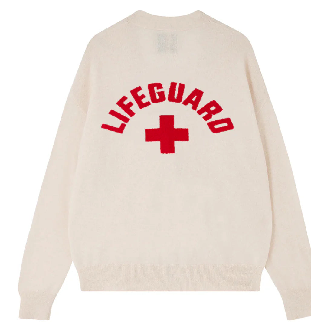 A JUMPER1234 Lifeguard Cardigan showcasing "LIFEGUARD" in bold red letters and a red cross symbol on the back.