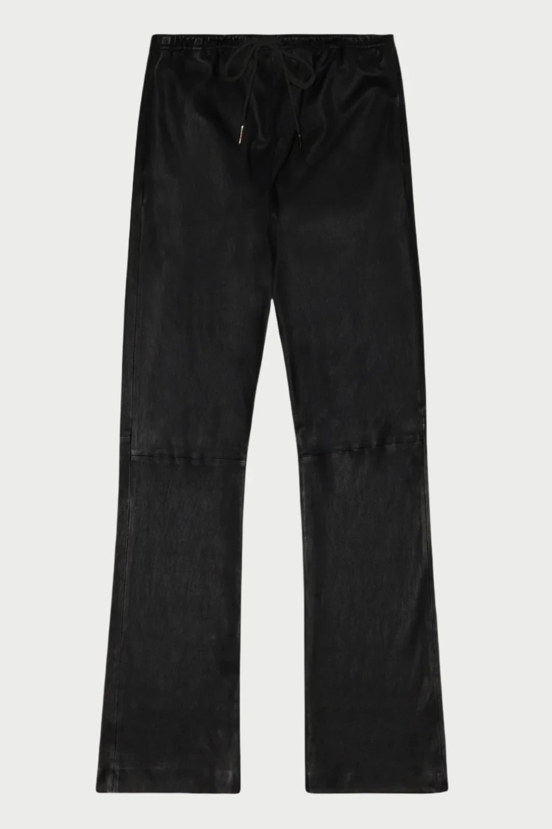 The Leather Drawstring Straight Leg Pant by SPRWMN is showcased against a white background. These black pants have a relaxed fit with a subtle sheen, detailed seams at the knee area, and are crafted from stretchy French plongé leather. The drawstring at the waist allows for adjustable comfort, providing a luxurious appearance.