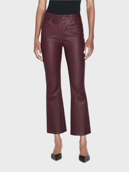 A person is standing against a plain white backdrop, highlighting the Le Crop Mini Boot Leather Pants in burgundy lambskin stretch leather by Frame, paired with sleek black pointy shoes. The absence of the upper body allows these chic Fall fashion pants to take center stage.