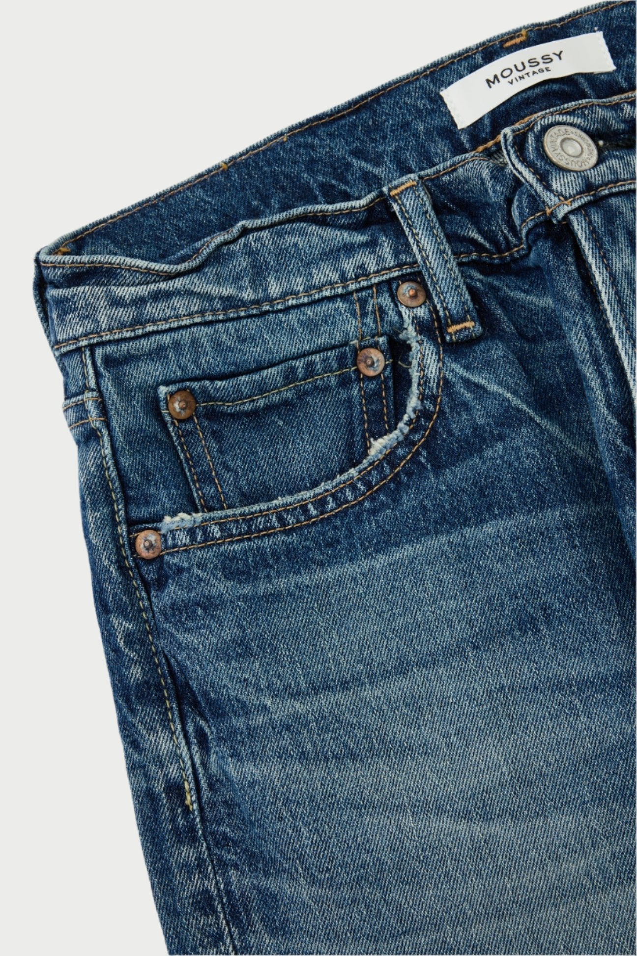 Close-up of Florahome Slim Straight Jeans in blue denim, showcasing a front button, two pockets with copper rivets, and a small coin pocket. Crafted from heavyweight denim, these mid-rise jeans display a textured, worn look with visible stitching. The waistband features a partially visible label that reads "Moussy.