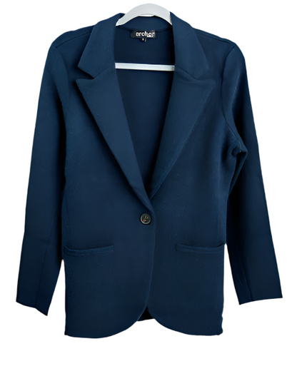 A navy Archer Cashmere Blazer with a single-button closure and two front pockets hangs elegantly on a white hanger.