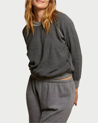 Wearing a Ziggy Sweatshirt in Dark Heather Grey from perfectwhitetee, featuring buttery soft fleece and exposed seam detailing, paired with matching pants against a plain background for a comfortable and relaxed look.