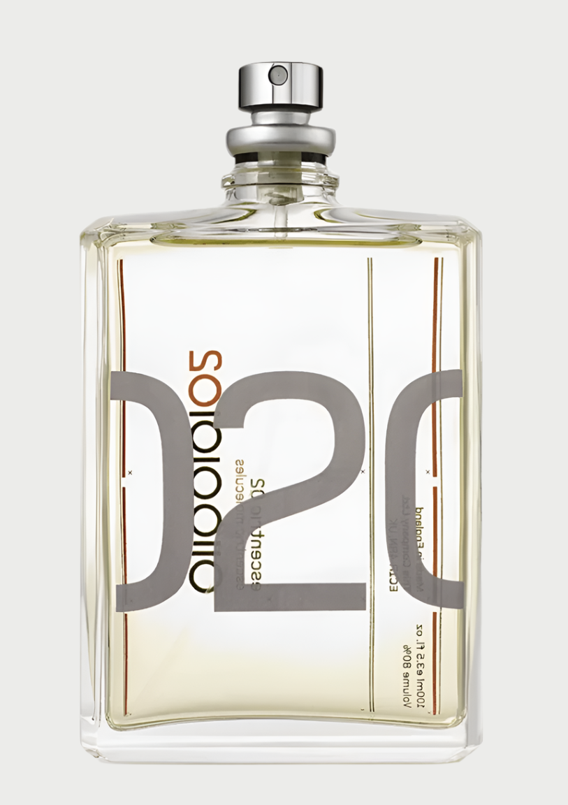 A transparent glass perfume bottle with a metallic spray nozzle at the top. The minimalist design features abstract text and numbers, including "Escentric Molecules" and "02" in a modern font on its front label. The fragrance inside is light amber in color, featuring notes of Ambroxan.