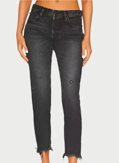 A person wearing the Merry Tapered Mid Rise Jeans by Moussy, featuring distressed black denim with frayed hems and subtle rips, crafted from premium Japanese fabric, stands against a plain background.