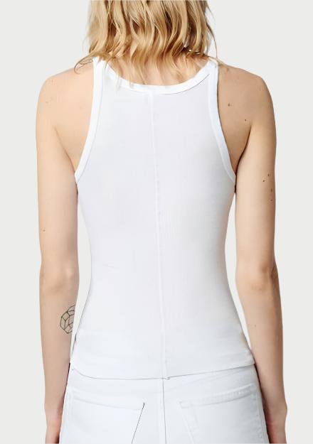 A person with shoulder-length, wavy blonde hair is facing away from the camera, wearing a RE/DONE Ribbed Tank made of 100% cotton and white pants. A small geometric tattoo is visible on their right upper arm.